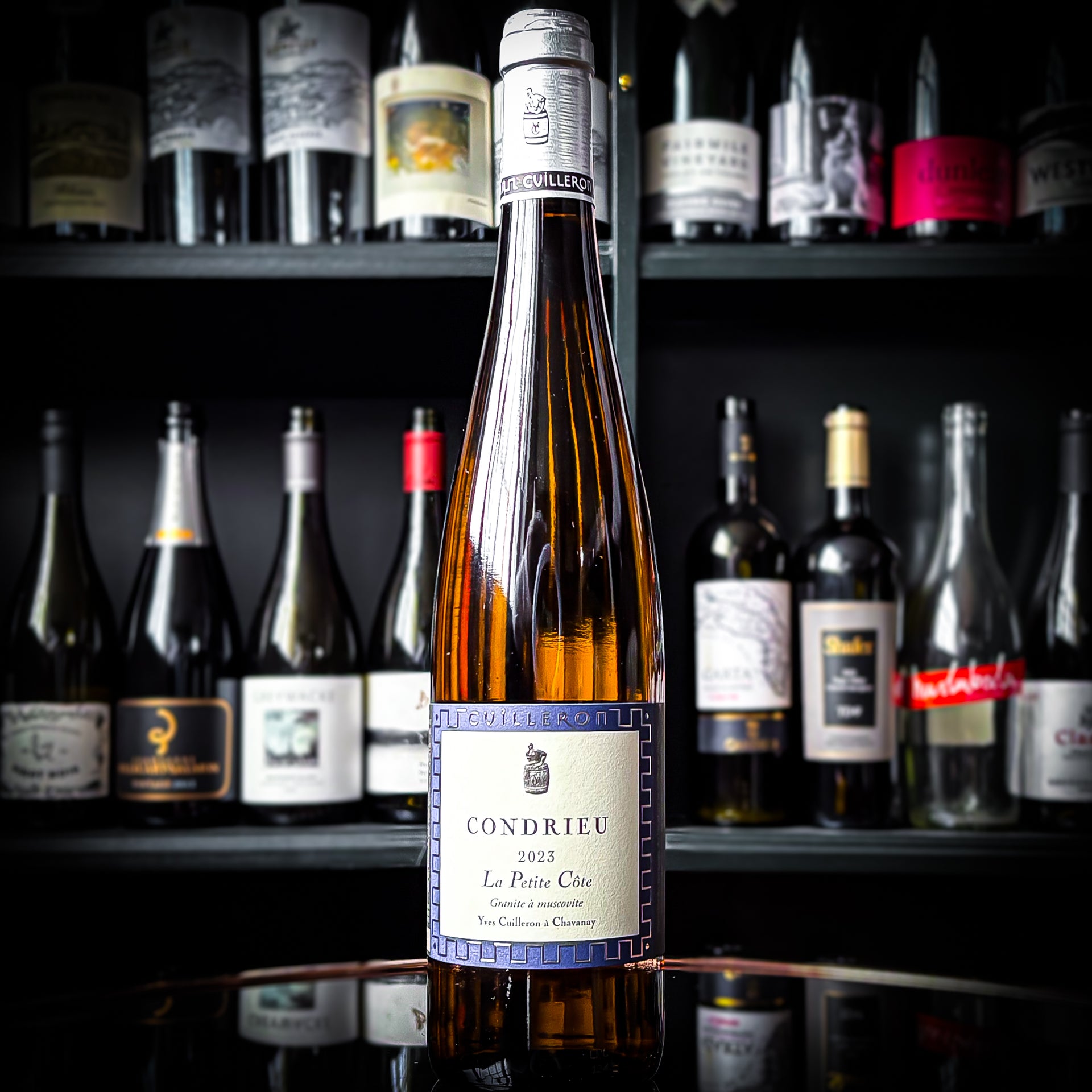 Yves Cuilleron Condrieu La Petite Côte bottle in a wine shop setting
